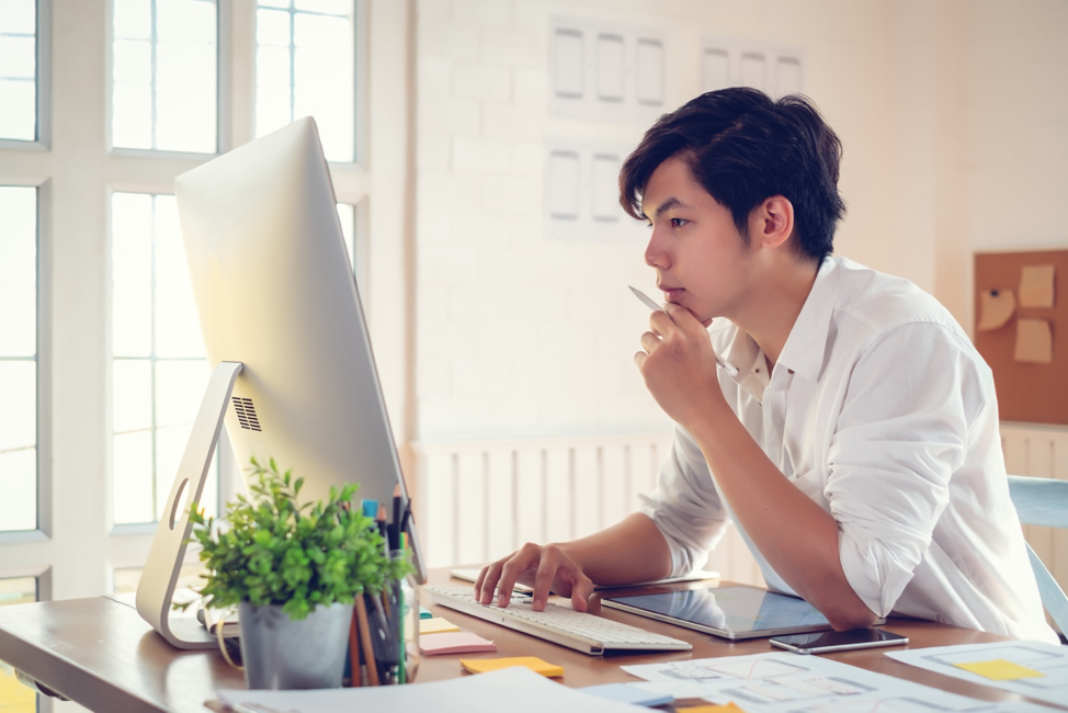 A man at a desk figuring out how to Launch a WordPress Site